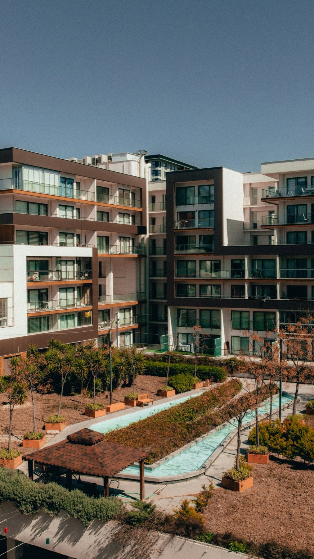 Apartment complex with balconies and a landscaped courtyard